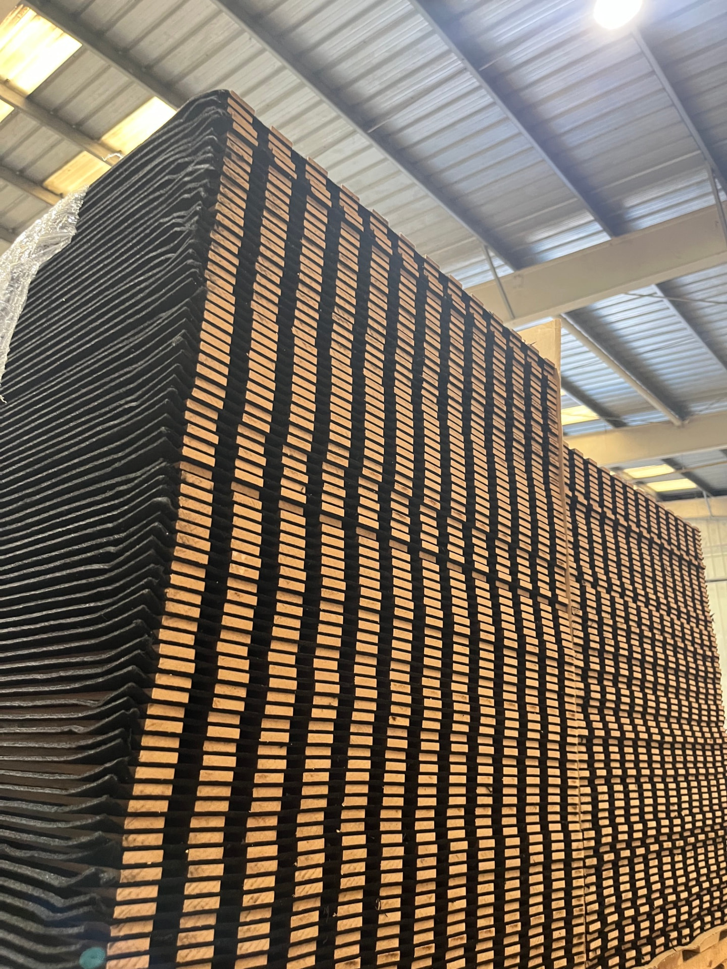 Full pallet of acoustic wall panels stacked high in the warehouse
